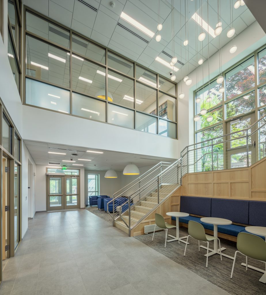 view of interior atrium with tables and chairs and lots of windows