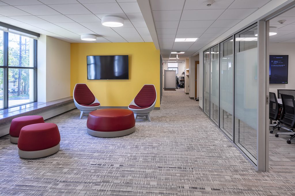 Modern office renovation with bright colors and glass walls to maximize natural light and support collaboration