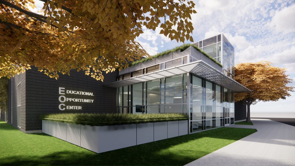 A renovated university building with a new glass entrance and terraced outdoor seating above it