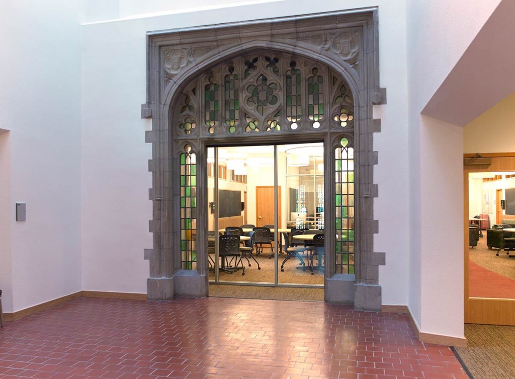 Historic college renovation preserving detailed doorways and arches