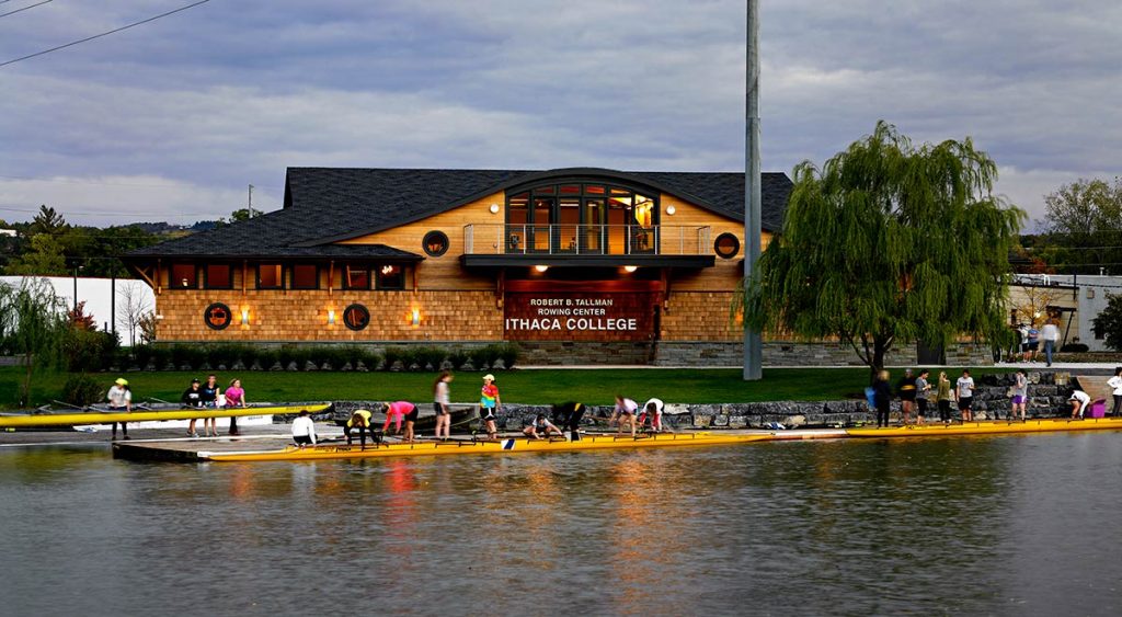 A cedar-clad building exterior with an overarching roofline that mimics famous historical boathouses